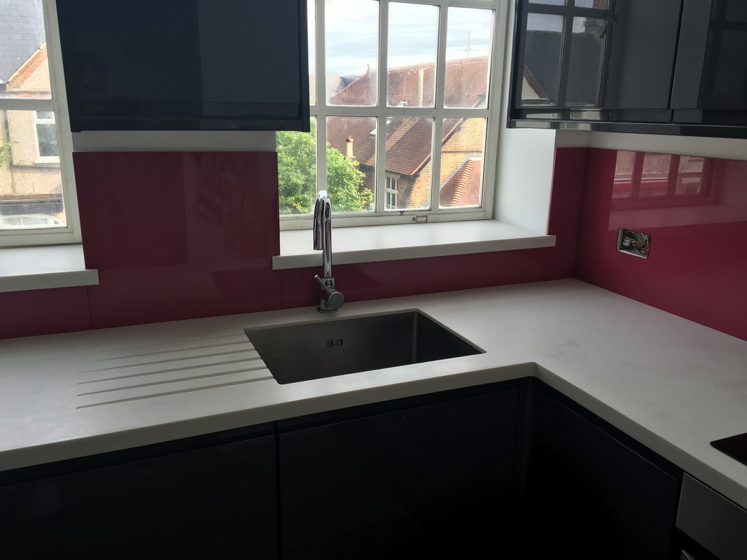 Deep plum coloured glass splashback in modern Highbury kitchen